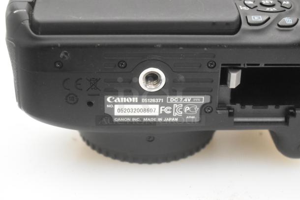 Hard black case containing Canon DS126371 camera body, Canon Battery Grip BG-E8. Visible model labels and serial number.