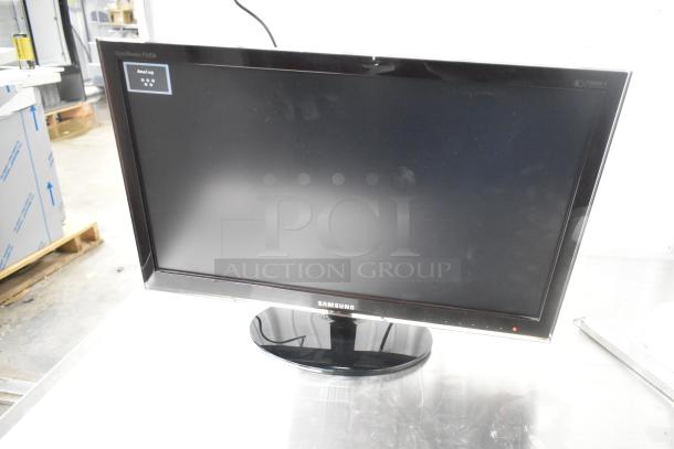 Samsung P2450 monitor in original box, tested and working. Sleek design with a glossy black frame.