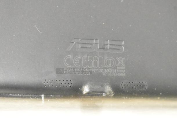 Asus K008 Tablet showing model and certification markings, enclosed in Case Logic case.