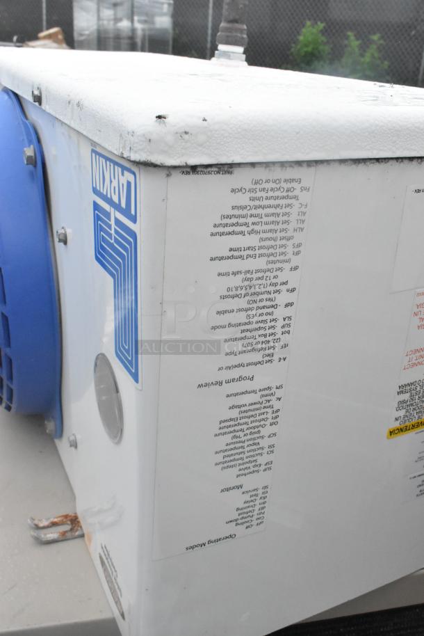 Thermalrite Walk-In Box corner, featuring a Heatcraft condenser with markings for settings and maintenance instructions.