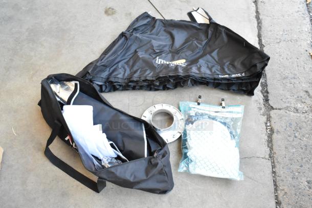 Lot of various items including Impact Aputure gear in poly bin, featuring a black bag, folded fabric, and accessories.