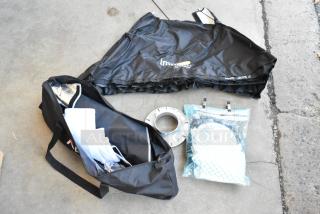 Lot of various items including Impact Aputure gear in poly bin, featuring a black bag, folded fabric, and accessories.