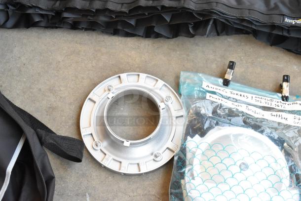 Lot of mixed items in poly bin, including an Impact lighting part and Aputure accessory. Visible labels, various conditions.