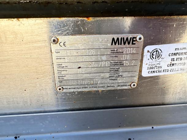 MIWE EC 8.1826 label showing model, serial number, voltage 208V, and manufacturing details. ETA and CE marks visible.