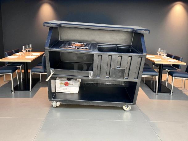 Portable Cambro BAR540DS bar in excellent condition, black, with ice sink and storage, wheels for mobility, fully tested.