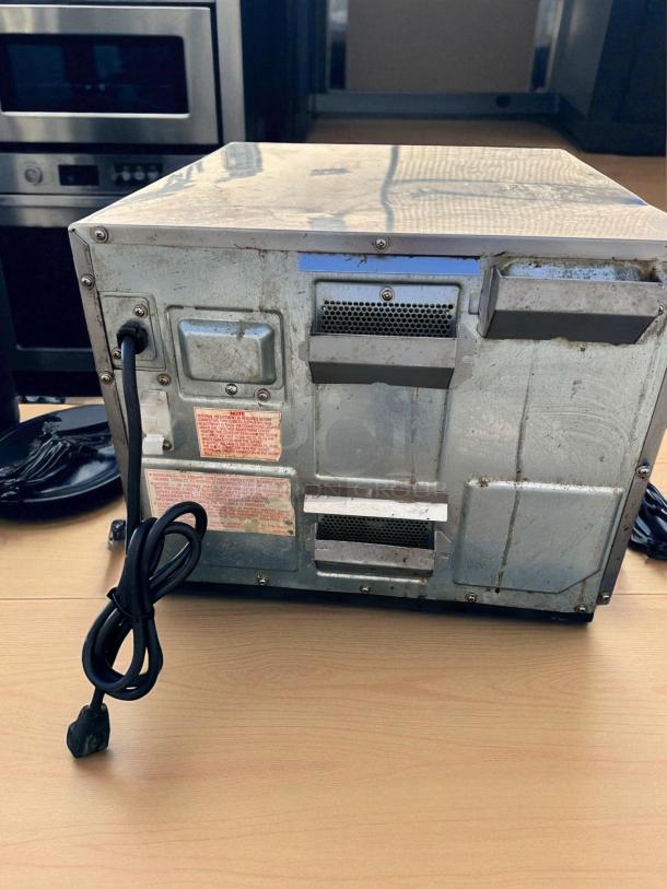 Panasonic commercial microwave, heavy-duty stainless steel, excellent condition, visible side vents, power cord attached.