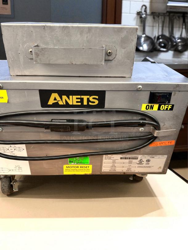 Anets FFM80 commercial fryer filter machine, excellent condition, 115V, with on/off switch, motor reset label, and wheel casters.