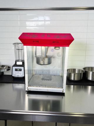 Vintage-style commercial popcorn machine in excellent condition, fully tested and working, with decorative red top.