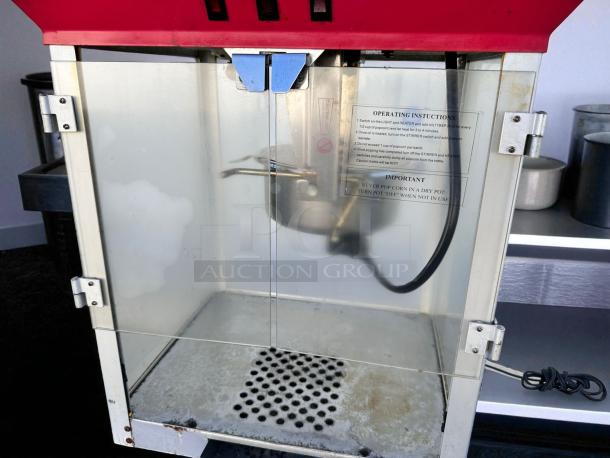 Vintage-style commercial popcorn machine in excellent condition, fully tested and working, with operating instructions displayed.