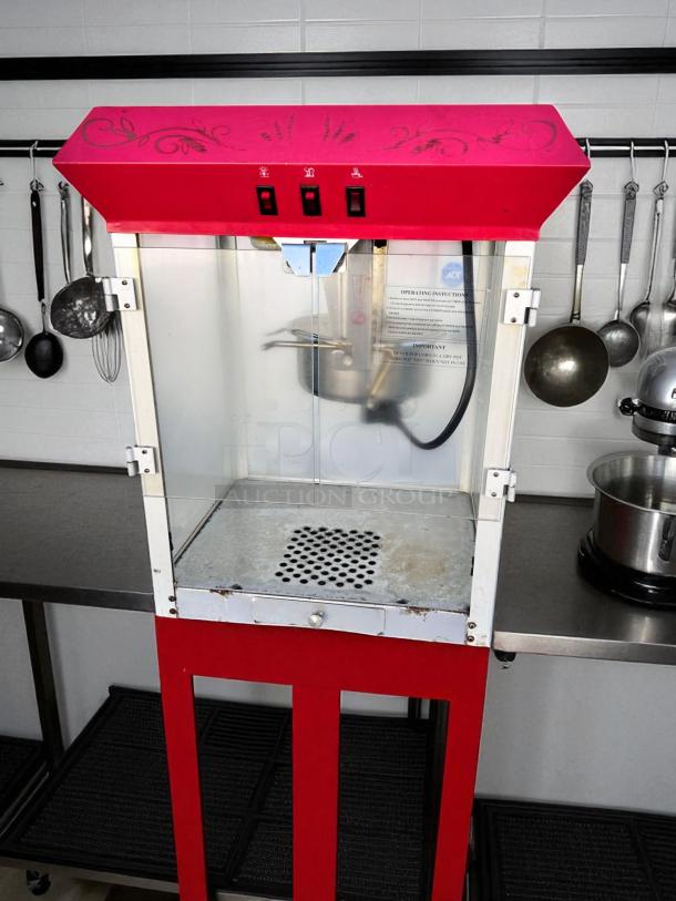 Vintage-style commercial popcorn machine, excellent condition, red design, fully tested and working, with operating instructions visible.