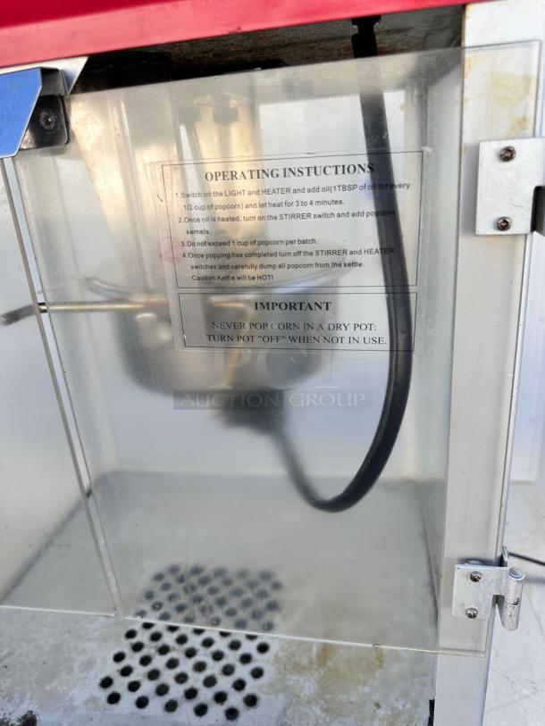 Vintage-style commercial popcorn machine, excellent condition, fully tested. Visible operating instructions inside glass panel.