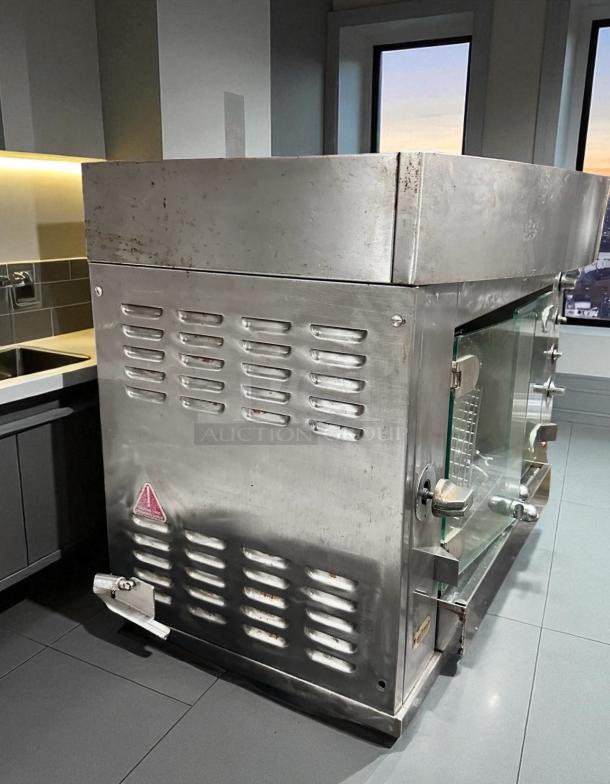 Rotisol 950-2 gas rotisserie oven, natural gas, excellent condition, fully tested, stainless steel exterior with glass doors.