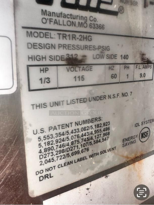 Label on a True TR1R-2HG refrigerator, showing model, voltage 115V, and patents. NSF certified, energy-saving.
