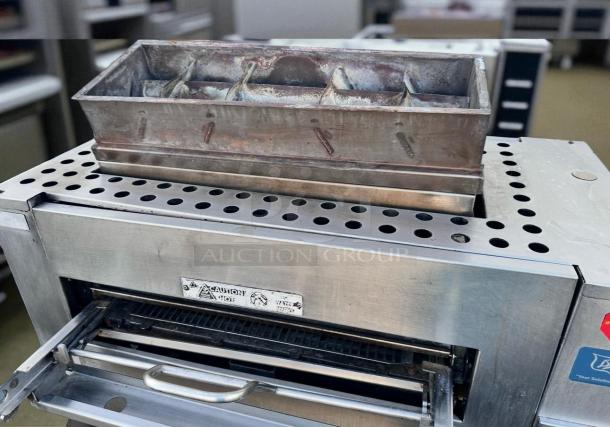 Duke FBB-NC-120 Gas Conveyor Broiler in excellent condition, fully tested. Stainless steel with visible caution label.