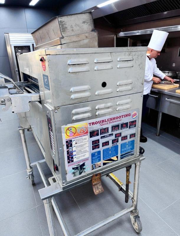 Duke FBB-NC-120 gas conveyor broiler in excellent condition; Burger King model with visible troubleshooting guide.