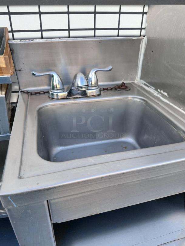 Stainless steel drop-in hand sink with dual-handle faucet, excellent condition, 18.5" x 17.5" x 18.5".