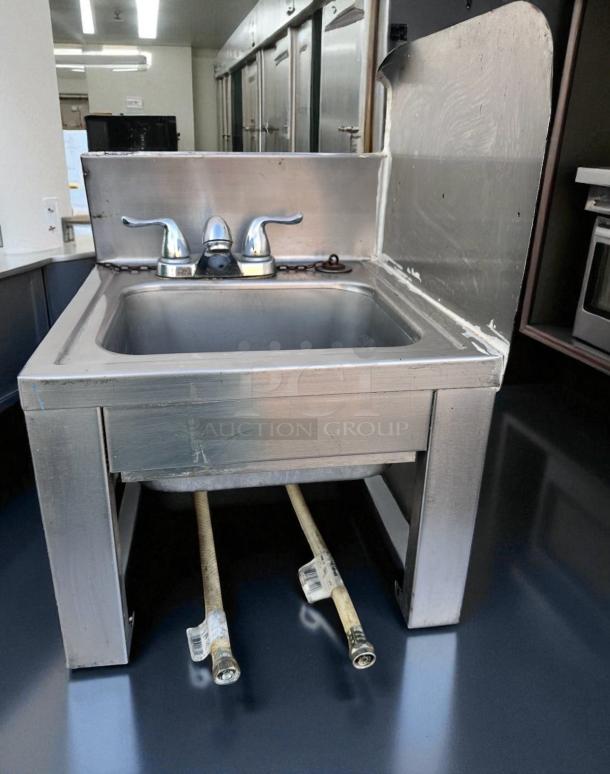 Stainless steel drop-in hand sink with dual-handle faucet, 18.5" x 17.5" x 18.5", excellent condition, ready to use.