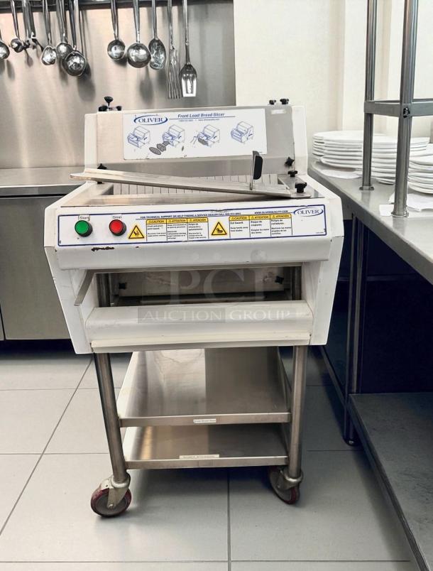 Oliver 702N front load bread slicer, excellent condition, fully tested, 115V, visible controls, dimensions and details on labels.