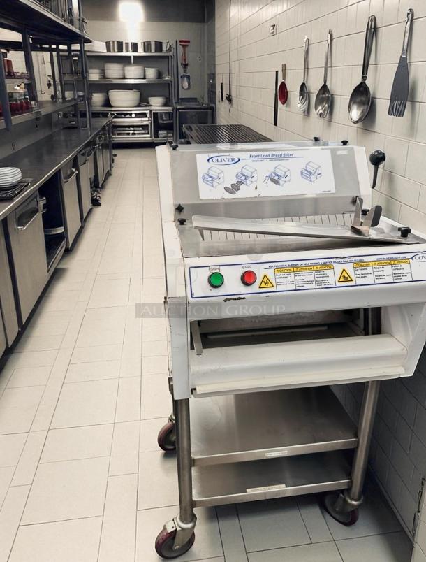 Oliver 702N front load bread slicer, excellent condition, 115V, fully tested, with control buttons and caution labels visible.