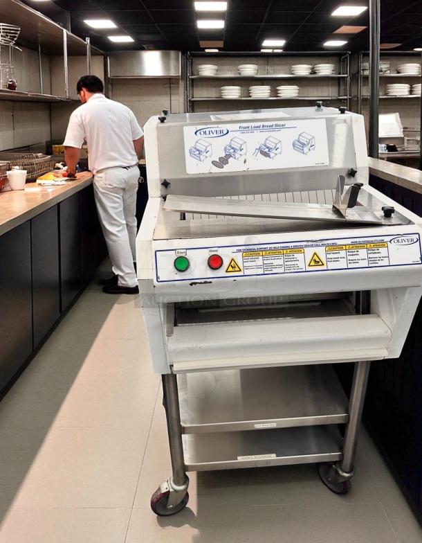 Oliver 702N front load bread slicer in excellent condition, 115V, stainless steel with control panel, fully tested and working.