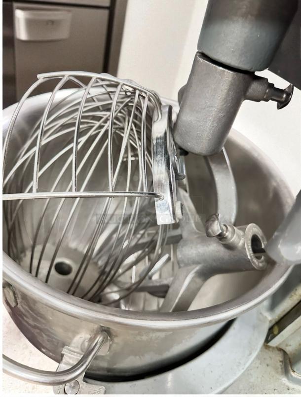 Hobart HL200 20 Qt commercial planetary mixer in excellent condition, fully tested, showing stainless steel bowl and whisk attachment.