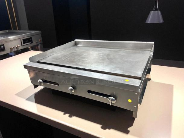 36" commercial flat top griddle in outstanding condition. Features three knobs, tested and working.