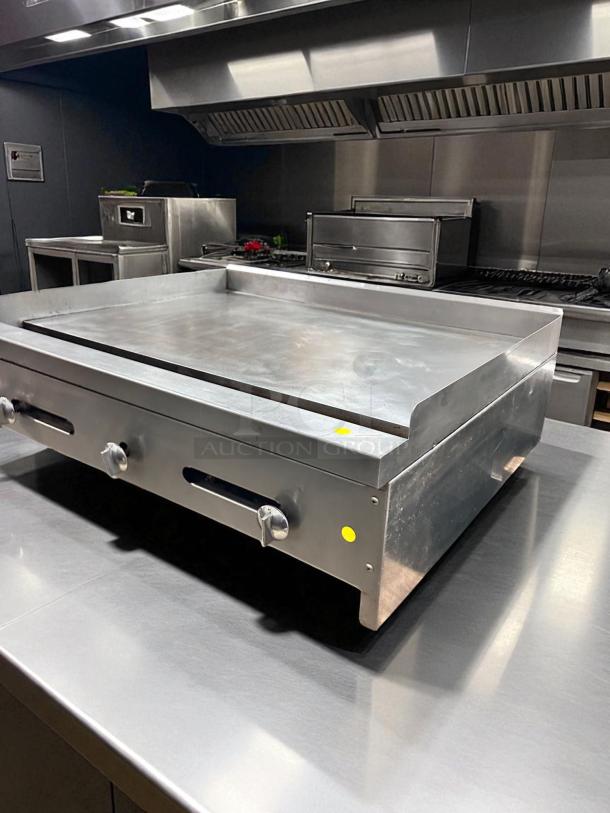 36" commercial flat top griddle in working condition, stainless steel, with control knobs, tested and operational.