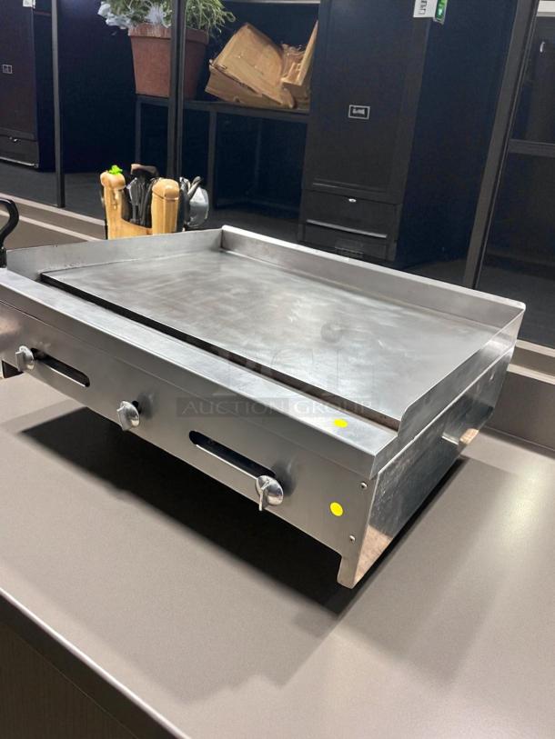 36" commercial flat top griddle in outstanding working condition. Tested and working; features sturdy metal construction.