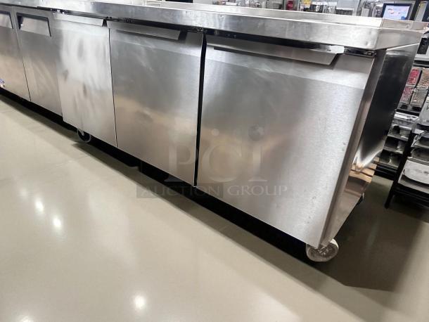Three-door stainless steel salad/sandwich prep table by Continental Refrigerator in excellent condition on castor wheels.