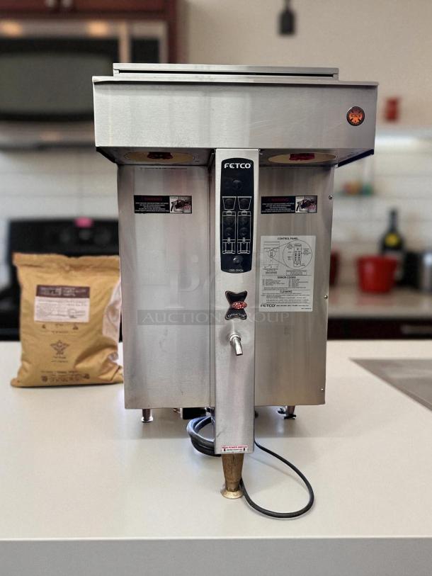 FETCO CBS-2042e Twin Station Coffee Brewer, stainless steel, 240V, tested, labels show operation and cleaning instructions.