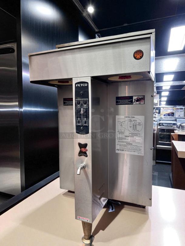 FETCO CBS-2042e Twin Station Coffee Brewer, stainless steel, 240V, fully tested, excellent condition, operational labels visible.