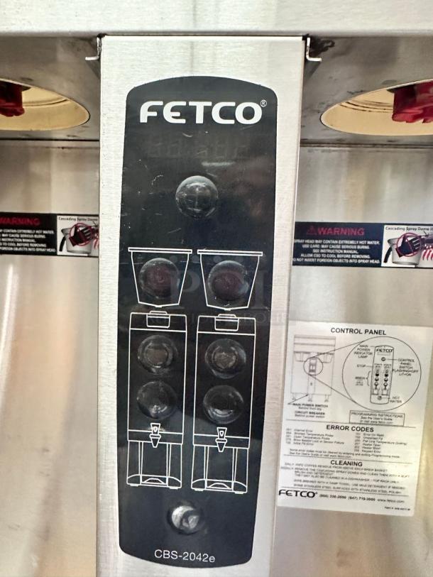 FETCO CBS-2042e twin station coffee brewer, 240V. Operational condition; control panel with labels and brewing guides visible.