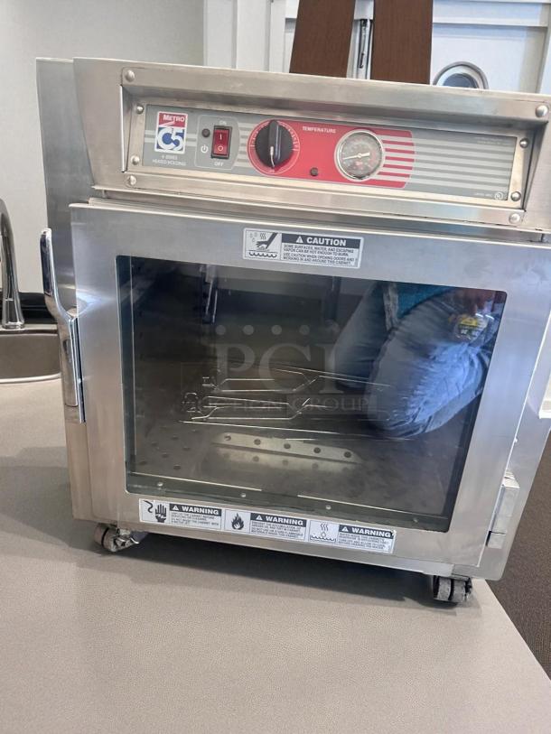 Metro C5 4 Series Heated Holding Cabinet, Model C563L-SFC-UA, excellent condition, temperature control, 120V, safety warnings visible.
