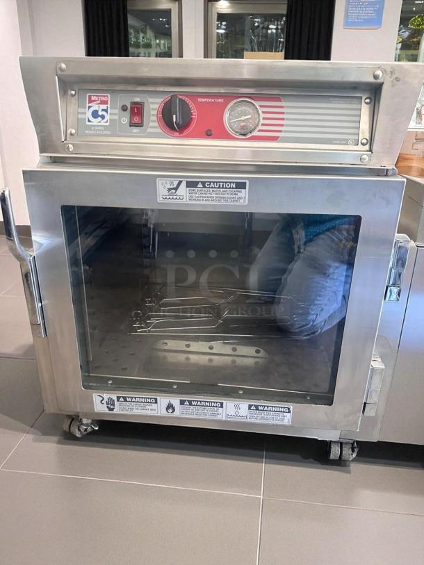 Metro C5 4 Series Heated Holding Cabinet, Model C563L-SFC-UA, excellent condition, 120V, temperature gauge, caution labels.