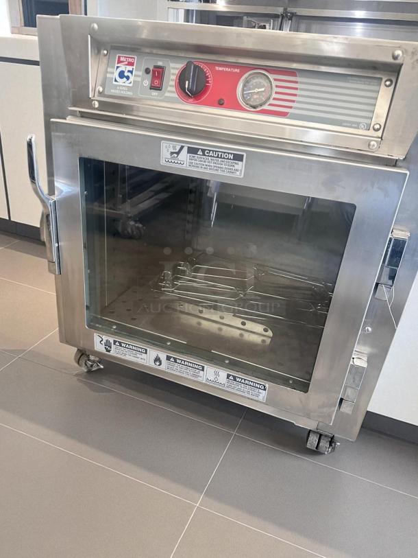 Metro C5 4 Series Heated Holding Cabinet, Model C563L-SFC-UA, excellent condition, 120V, fully tested, stainless steel, on wheels.