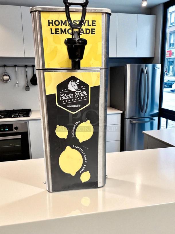 Newco FPM-1 countertop lemonade dispenser, excellent condition, NSF listed, with "Homestyle Lemonade" and "State Fair Lemonade" labels.