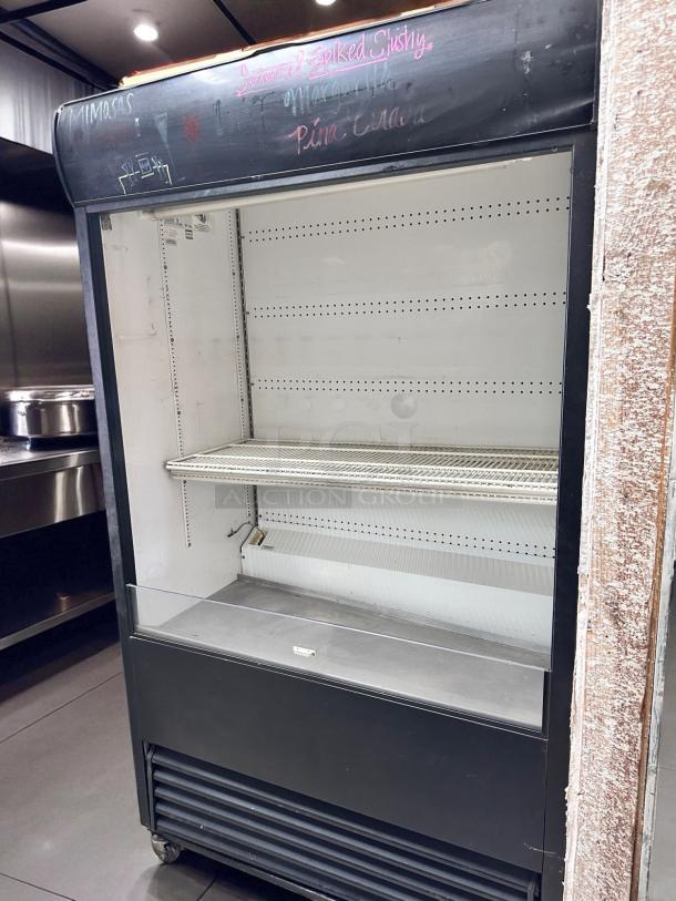 True TAC-48 refrigerated air curtain merchandiser, 48" in excellent condition, 208/230V, fully tested, shelves included.