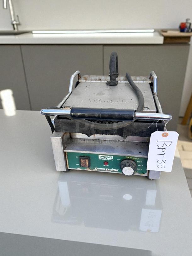 Waring Commercial Panini Perfetto press in working condition, tested. Features adjustable temperature control and sturdy metal body.