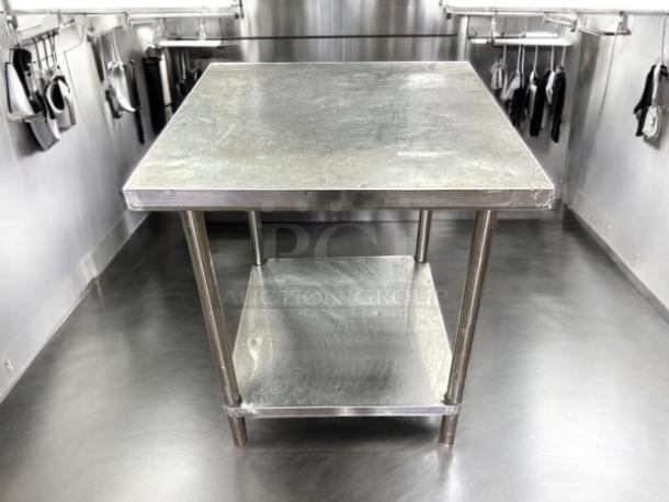 30-inch stainless steel worktop table, 30"W x 30"D x 34"H, excellent condition, tested and working, lower shelf included.
