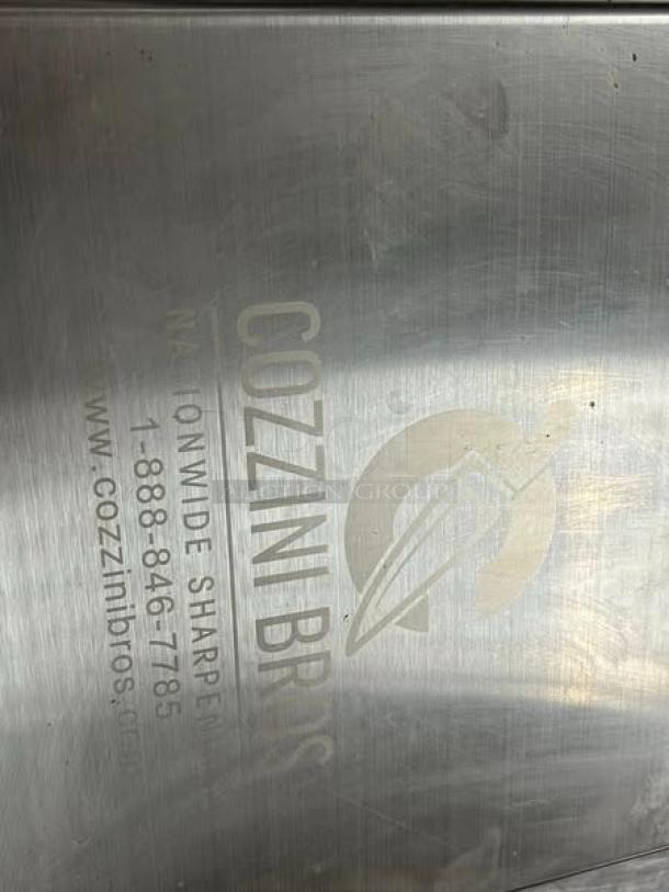 Cozzini Bros stainless knife rack, 12-inch, model #KS-SSKNR12. Excellent condition, tested and working, visible company logo.