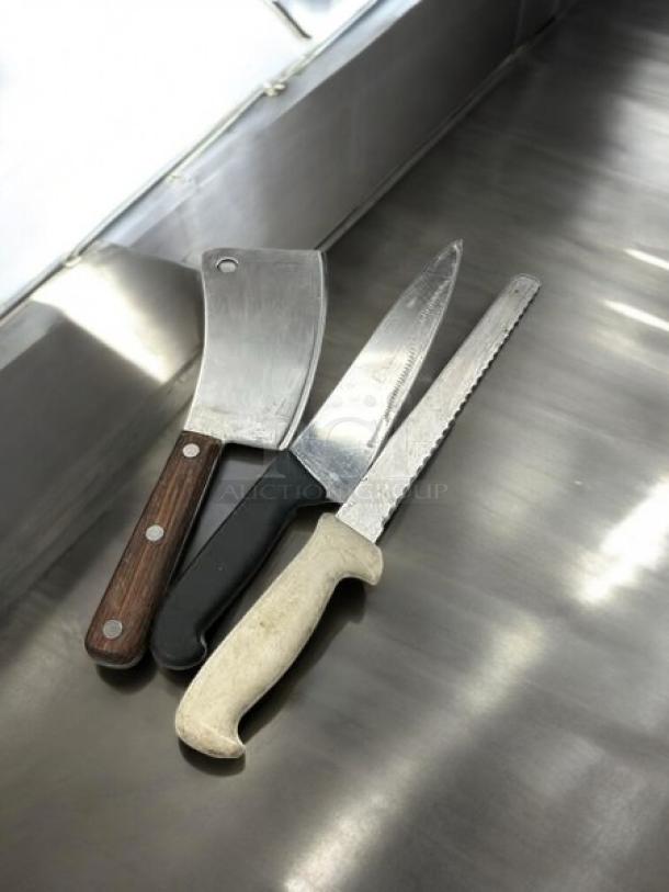 Three chef knives in great condition, including a cleaver, a chef's knife, and a serrated knife. Fully tested and working.