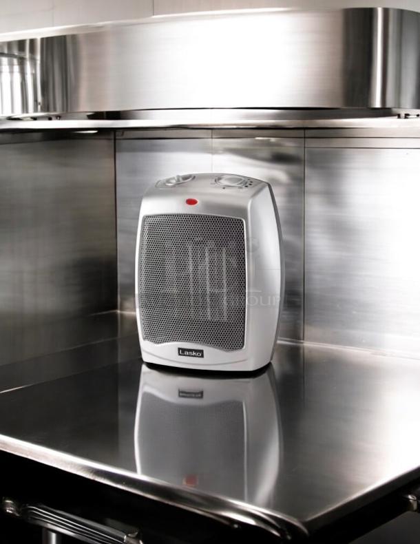 Lasko 100 sq ft electric portable heater, great condition, fully tested, white with control dials on top.