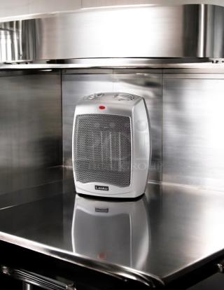 Lasko 100 sq ft electric portable heater, great condition, fully tested, white with control dials on top.