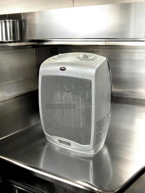 Lasko 100 sq ft electric portable heater in great condition, silver finish, with two control dials and front mesh grille.