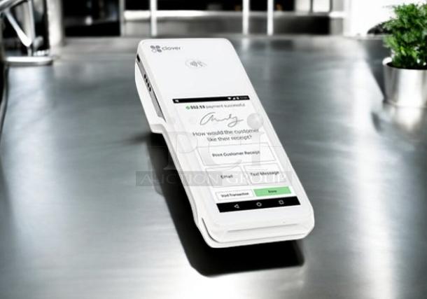 Clover Flex handheld POS system in excellent condition, on a table. Fully tested and working, white device with touchscreen.