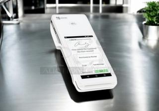 Clover Flex handheld POS system in excellent condition, on a table. Fully tested and working, white device with touchscreen.