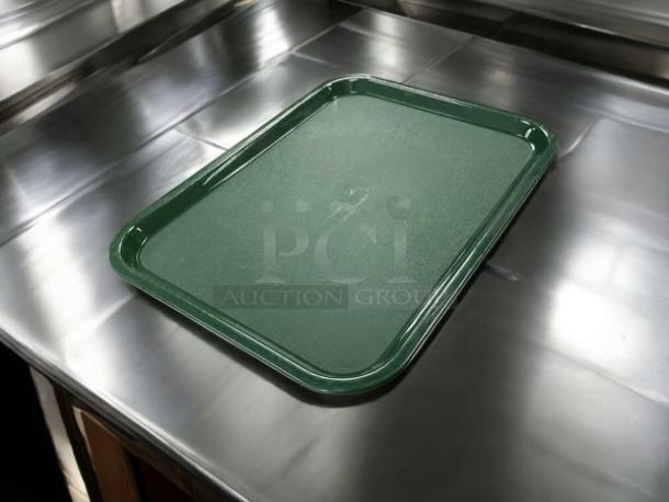 Brand new Carlisle CT141808 forest green polypropylene tray on a metal surface. Rectangular, durable, fully tested.