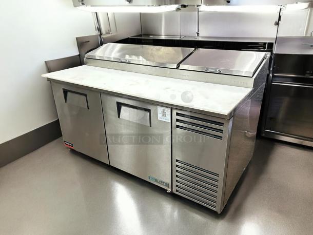 True TPP-AT-67-HC pizza prep table with refrigerated base, 67". Stainless steel, excellent condition, tested working.
