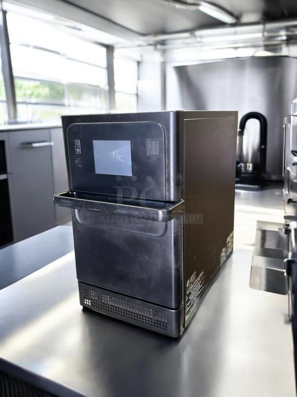 Merrychef eikon e1s countertop oven, black, great condition, 208/240V, tested, with touch screen display in stainless steel kitchen.