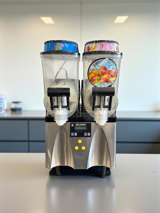 BUNN 34000.0080 ULTRA-2 Frozen Beverage System, 2 hoppers, silver, 115v, tested and working, clear front, brand label.